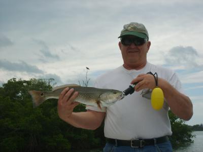 Dave Mathias with a slot redfish caught using live shrimp